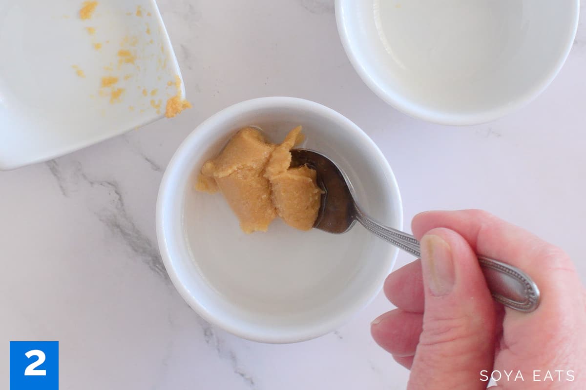 Mixing miso paste in sake and water.