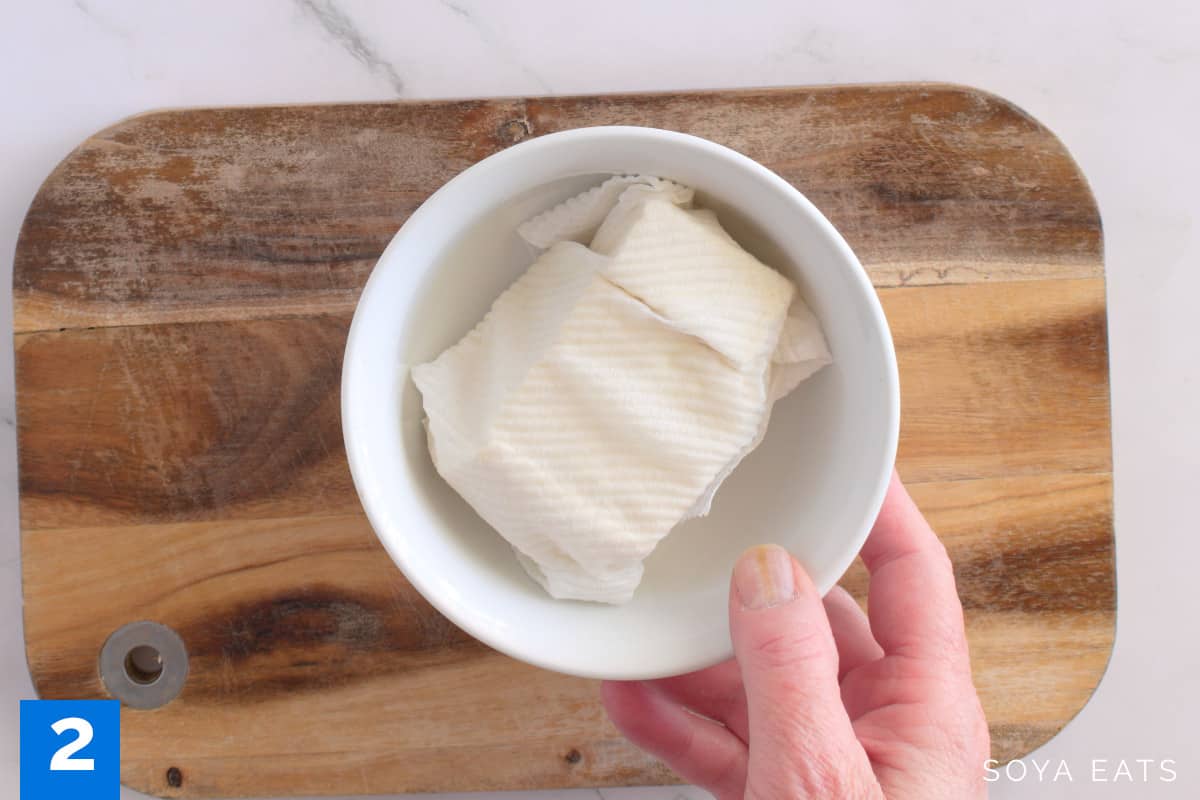 Tofu wrapped in kitchen paper.
