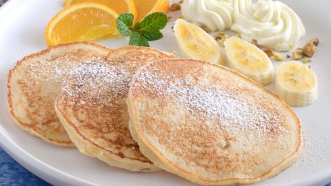 Banana okara pancakes on a white plate.