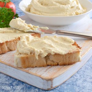 Vegan cream cheese substitute on slice of bread.