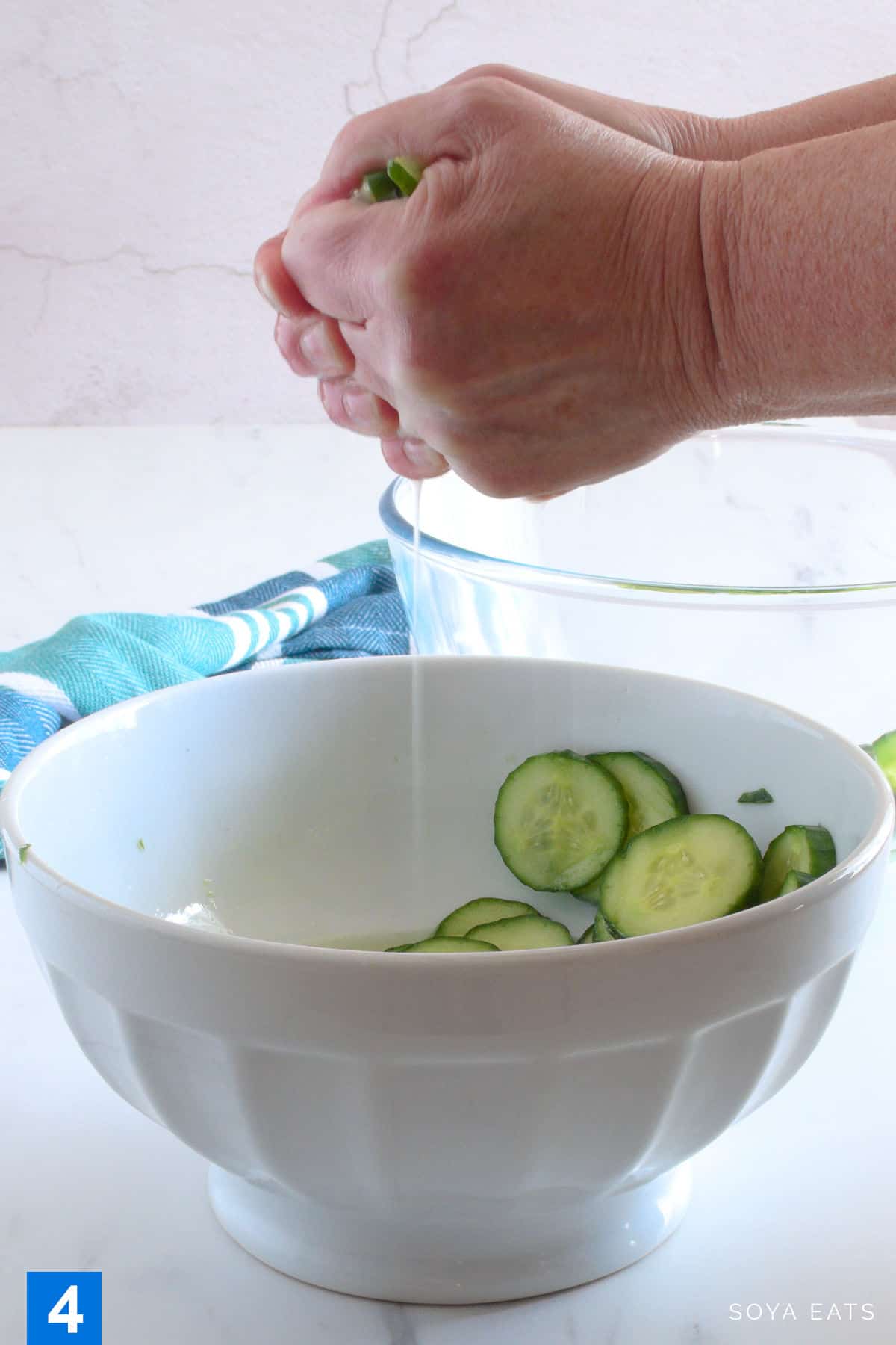 Squeezing liquid from cucumber slices.