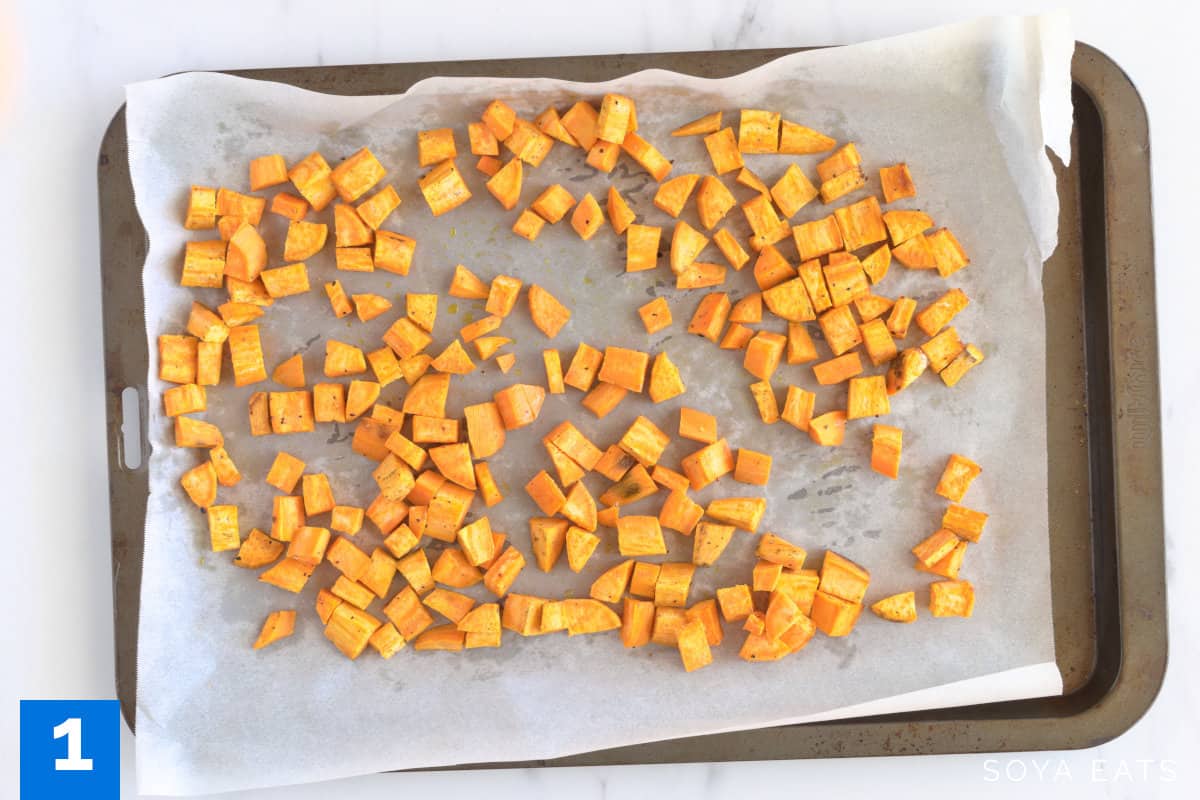 Baked sweet potato cubes on a tray.