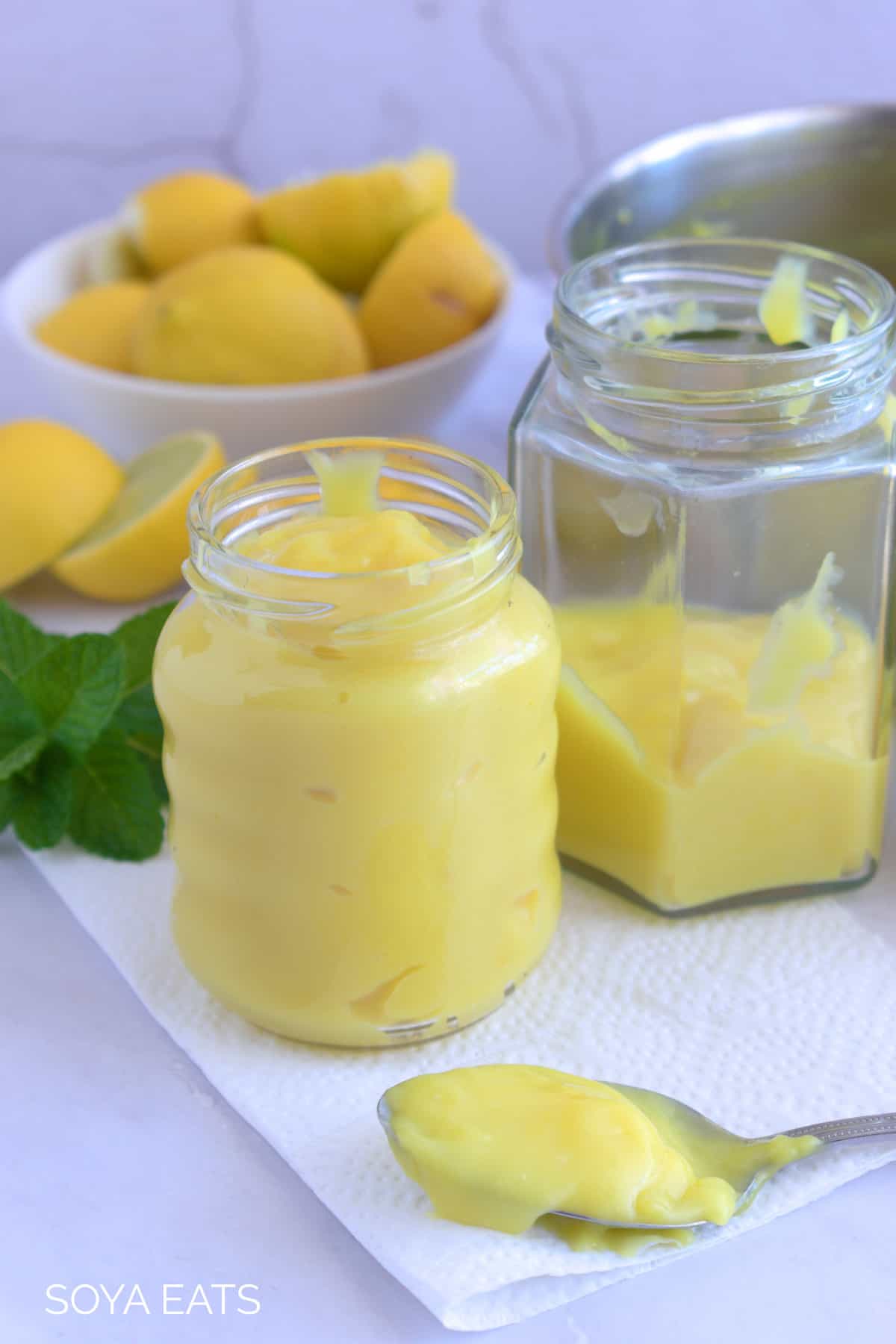 Two bottle filled with lemon curd.