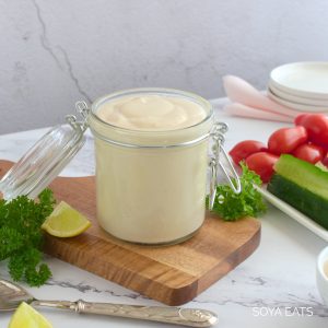 Low fat vegan mayo in a jar on a wooden board.