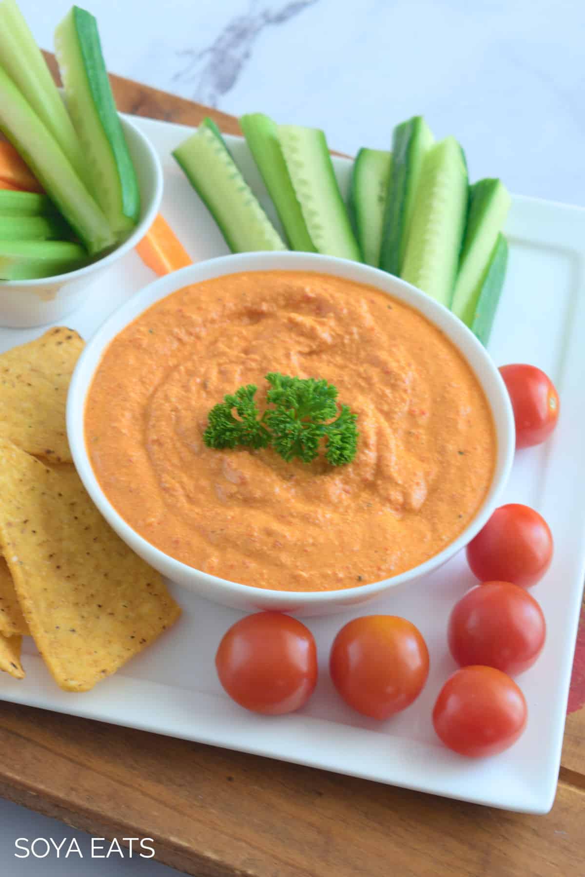 A top down view of dip in a bowl with veggie sticks on the side.