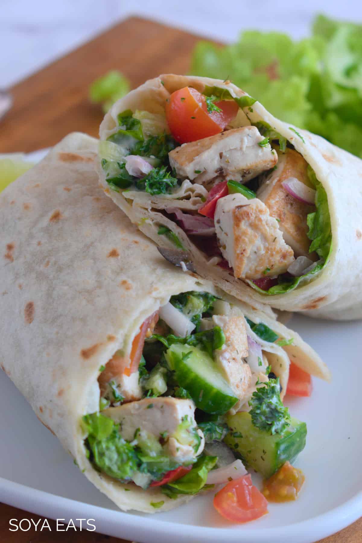 A close up image showing the inside of a cut  vegan Greek wrap.
