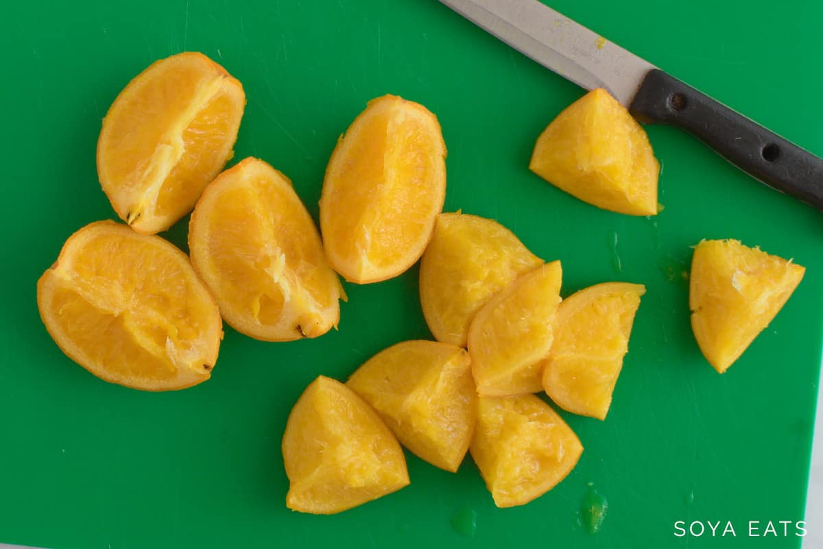 Cooked whole oranges cut into segments.